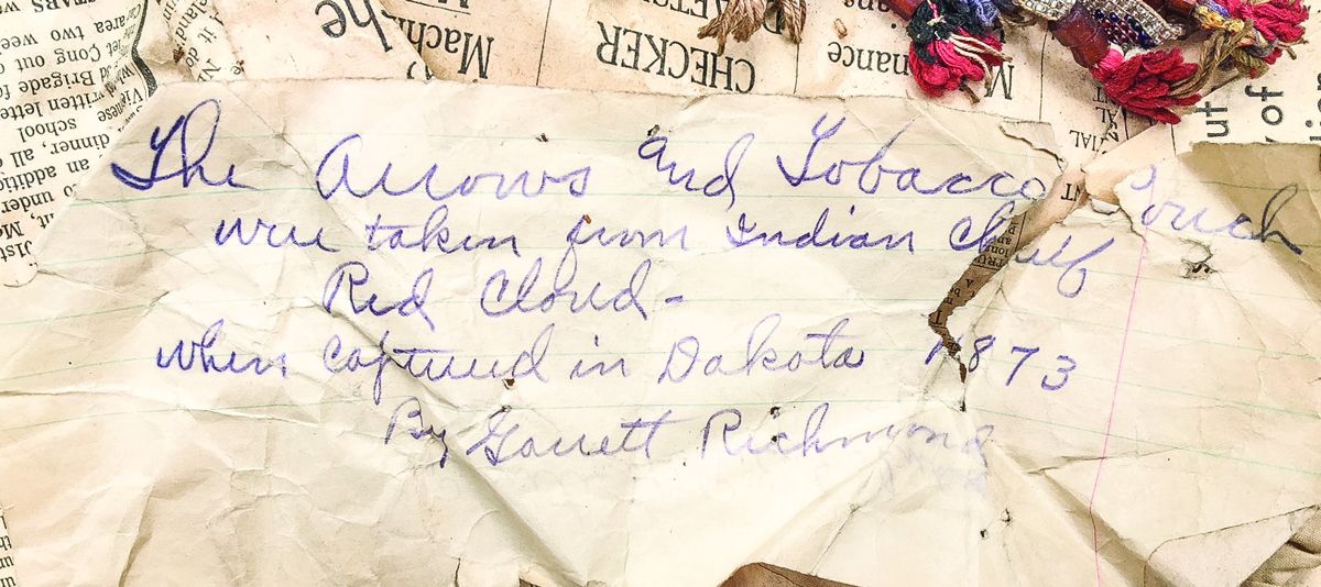 Tag stating that arrows and a tobacco bag were taken from Chief Red Cloud.