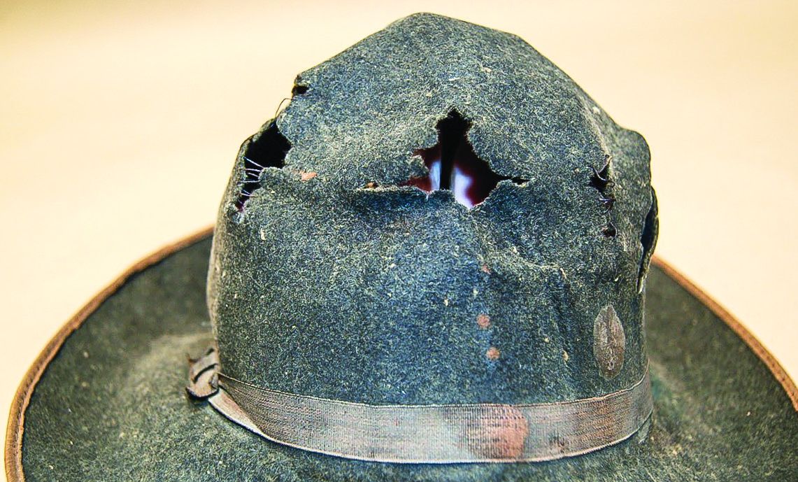 Holes in crown, front of hat, before treatment.