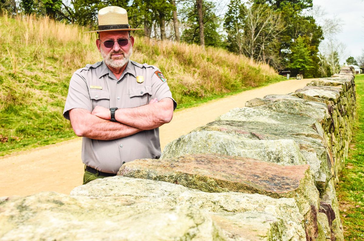 Greg Mertz – Ranger Greg Mertz serves as the supervisory historian with the Fredericksburg and Spotsylvania National Military Park. Mertz is standing in the Sunken Road behind a restored section of stone wall.