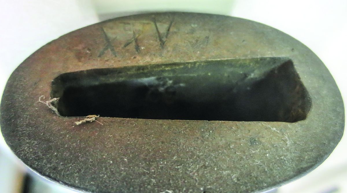 There are matching Roman numeral assembly marks on both the scabbard throat and the sword hilt.