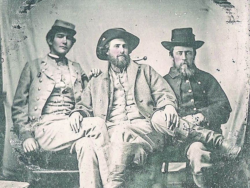 General Grimes sits in the center between two comrades.