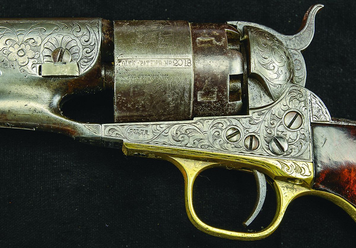 Note both guns engraved with similar design with punch dot backgrounds and “E” denoting factory engraving.