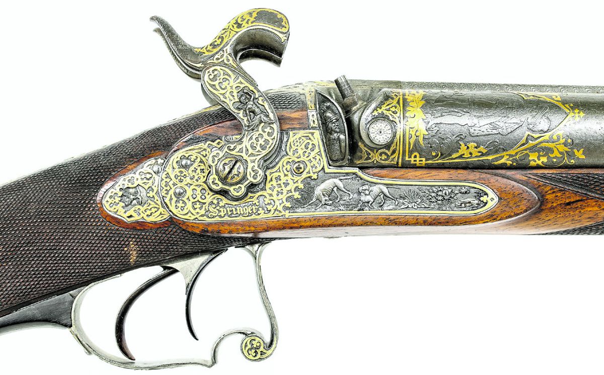 Obverse lock of the shotgun showing the ornate decoration of the lock and breech.