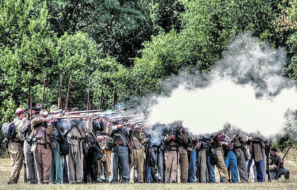 Confederate battle line firing their black powder rifles.