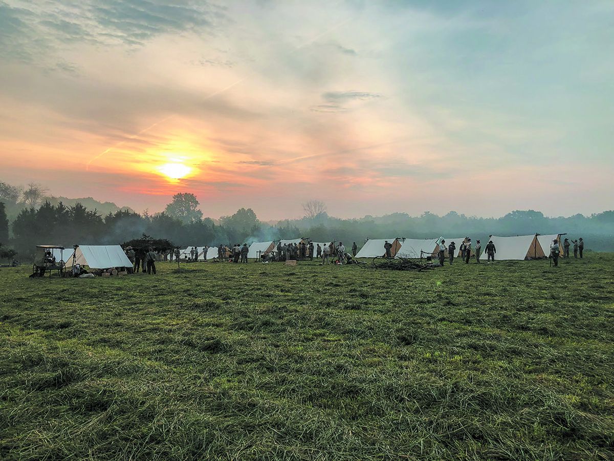 The sun rises over the 8th Virginia Infantry’s camp, laid out according to Confederate regulations, featuring hand-stitched fly tents made to wartime specifications.