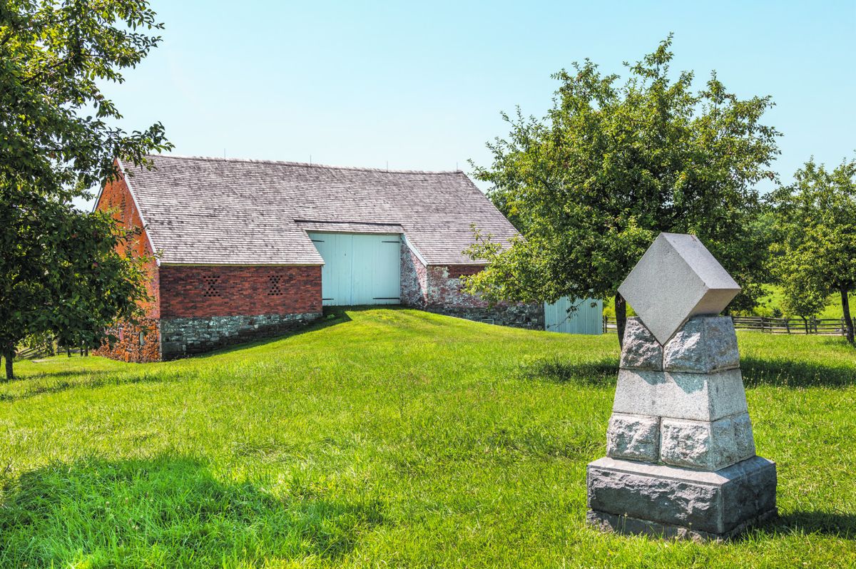 The monument to Union Major General Daniel Sickles is located on the Gettysburg Battlefield near the Trostle barn (shown in the background). The monument reads: Major General / Daniel E. Sickles / wounded / July 2, 1863.