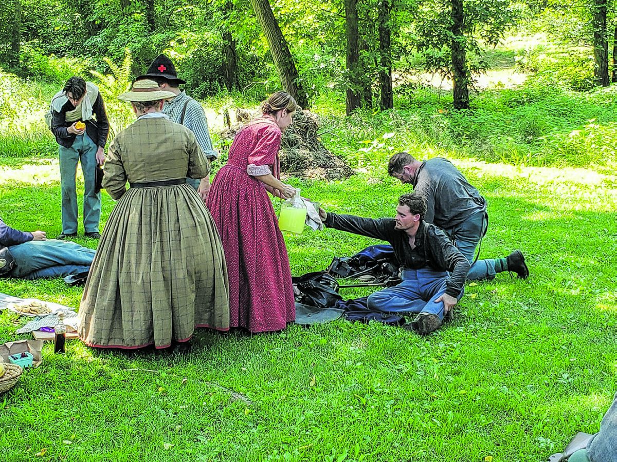 Terre Hood Biederman and Christina Herold giving refreshments to the soldiers at the Lightner Farm. (William J Watson)