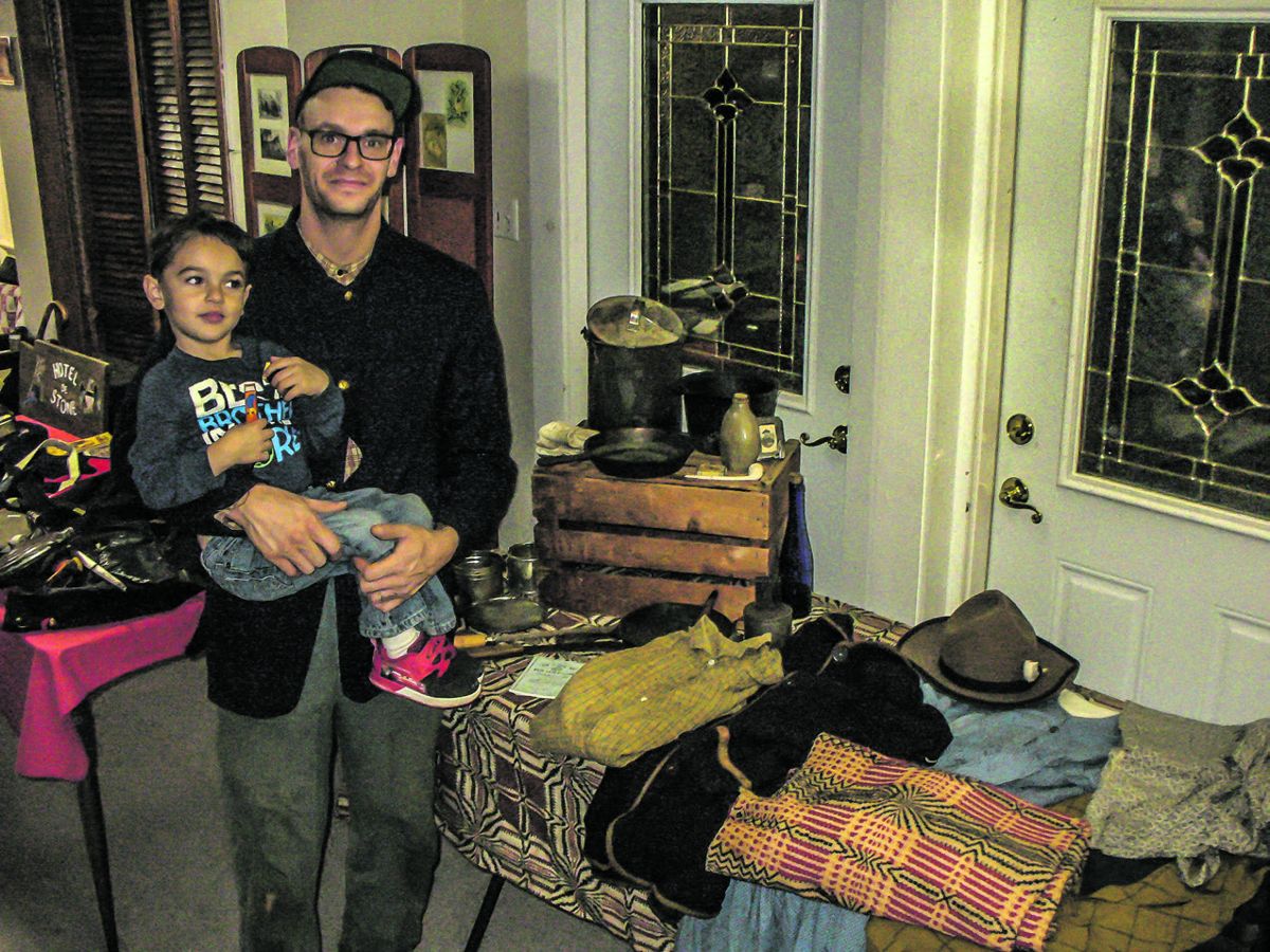 Dan Casella and his son Sebastian stand by a display of Dan’s