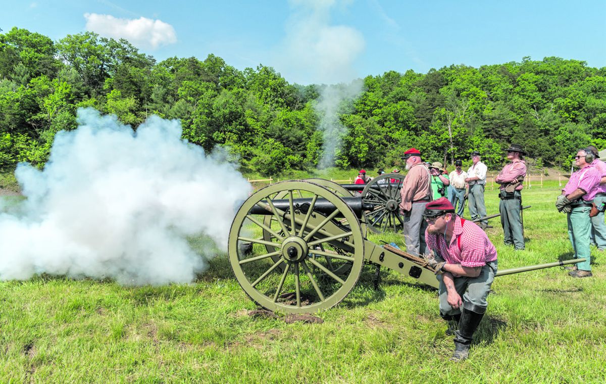 The position #4 crewman of the 3rd Maryland Artillery pulls the lanyard to fire their M1841 6-pounder gun as teammates watch the projectile fly down range toward its mark. (Ericka Hoffmann)