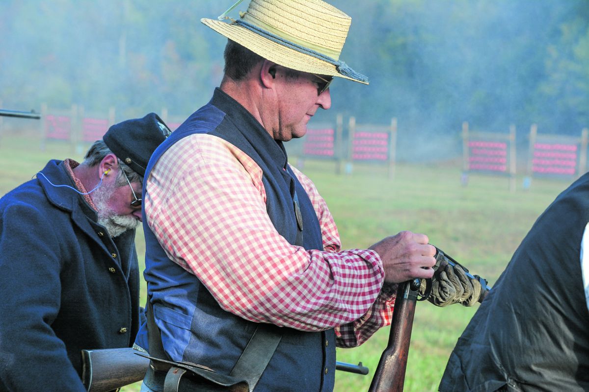 A competitor swiftly loads his Smith carbine during the carbine match on Saturday morning of the N-SSA 140th National Skirmish. The Smith is a popular arm with skirmishers, as are Burnside, Maynard, Sharps, and other original and
