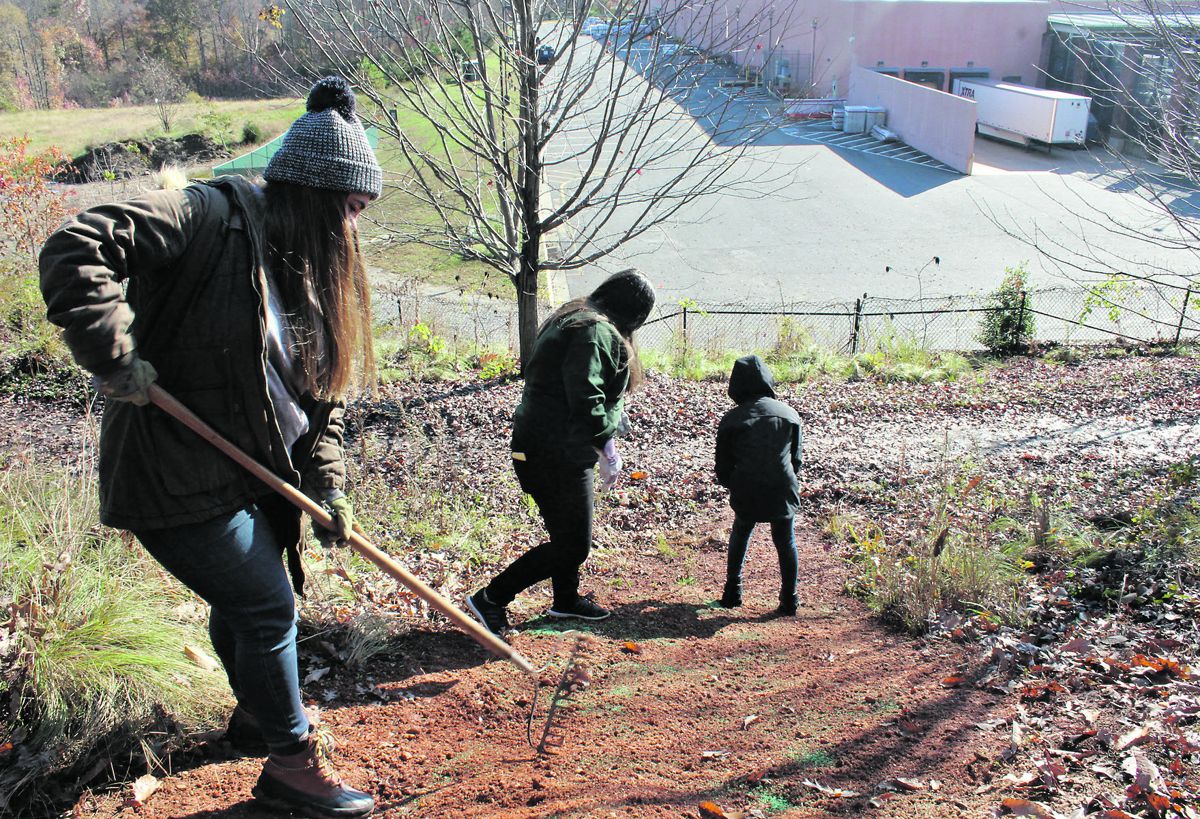 Heidi Dargal, Alexis Amos, and Makayla Foust, seniors at Riverbend High School, reseed a portion of Anderson Ridge as part of a Youth Community Service Day.