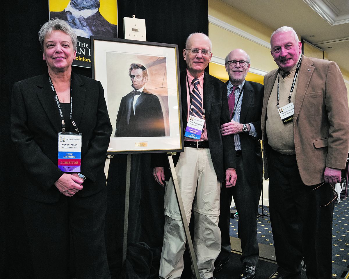 Artist Wendy Allen (L) helps present award named in her honor to Lincoln Studies Center at LSU Shreveport. Professor William Pederson accepts framed Lincoln print as Harold Holzer and Frank Williams look on.
