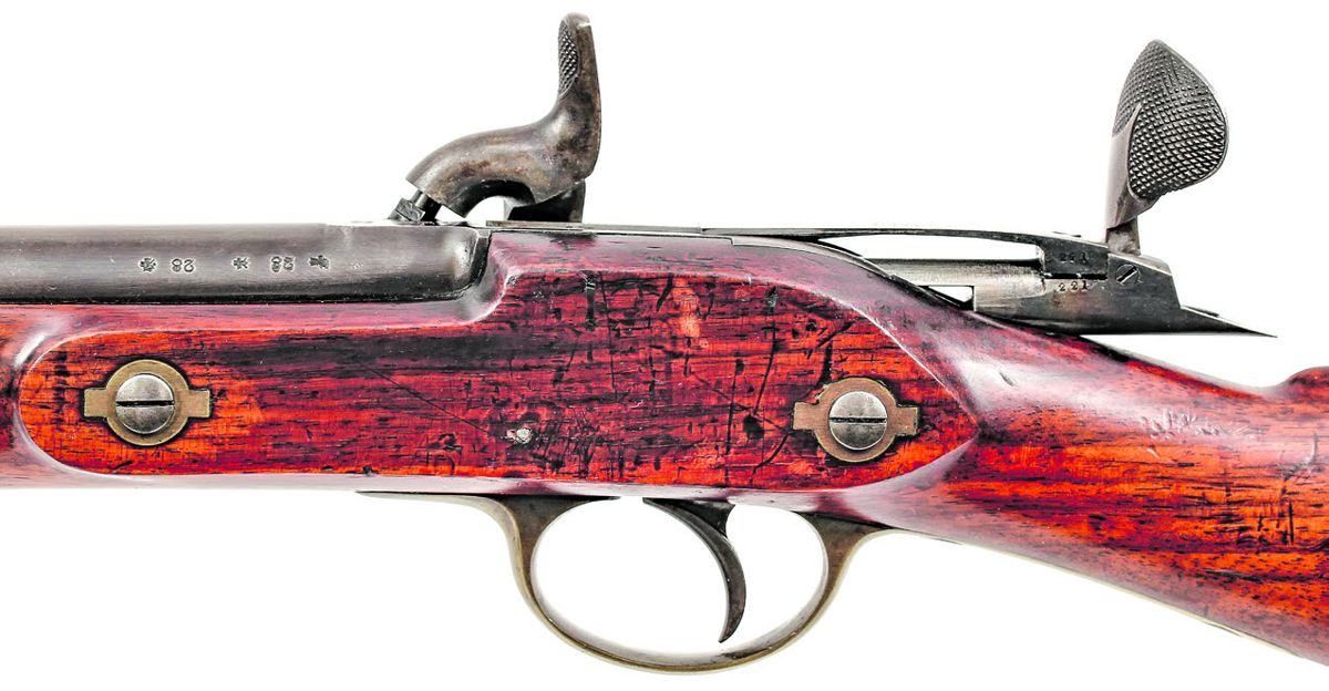 Reverse of Transitional Wilson Rifle with “Fish Tail” lever in the up position to provide a gripped surface for opening, or extra leverage for closing.
