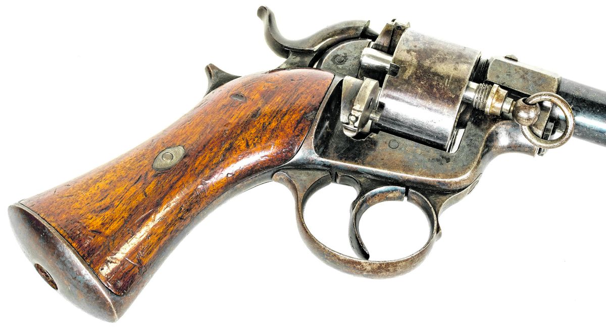 Raphael Revolver with the combination lanyard ring/ejector rod removed and inserted in a cylinder chamber to remove a cartridge.