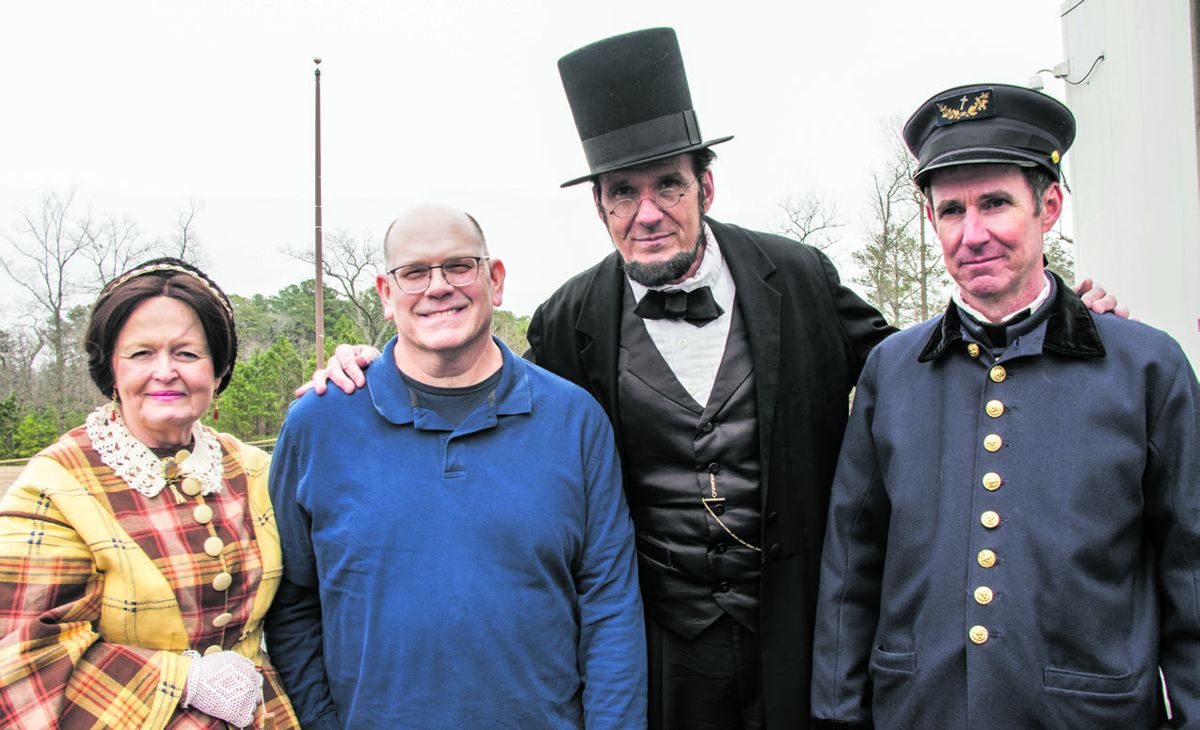 President and Mrs. Lincoln posed with John Stuck, a visitor from Portsmouth, Va., and Kurt Eberly, an interpreter with the Tidewater Maritime Living History Association, on the replica Monitor’s deck.