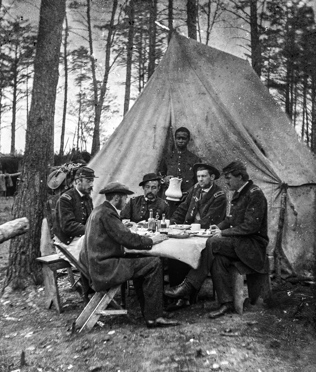 Brandy Station, Va. Dinner party outside tent, Army of the Potomac headquarters. Perhaps they are drinking tea with their (Library of Congress)