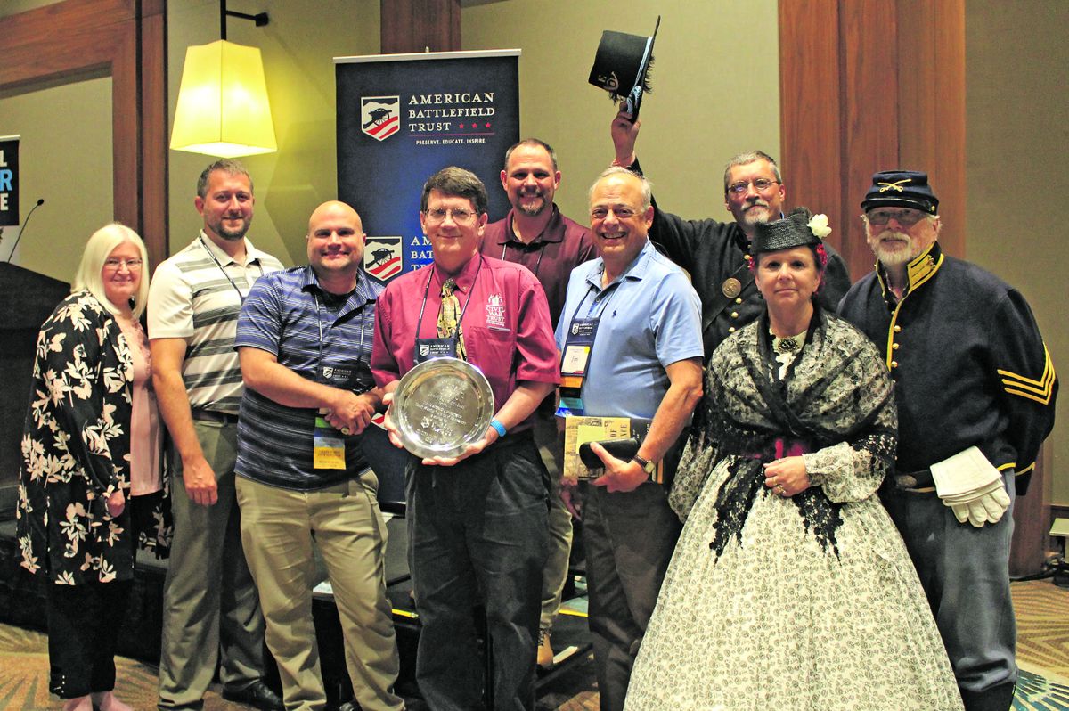 2019 American Battlefield Trust Teacher of the Year awardee Richard Houston (pictured at center with award plate), surrounded by fellow award-winning educators Shirley Mae Snyder, Tyler Madison, Phil Caskey, Bob Rinehart, Jim Percoco, Dave Wege, Carolyn Ivanoff and Dave Niekum.