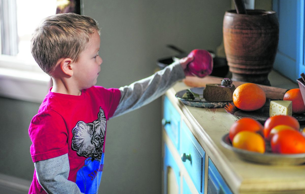 A young learner explores an interactive exhibit at the Rupp House History Center.