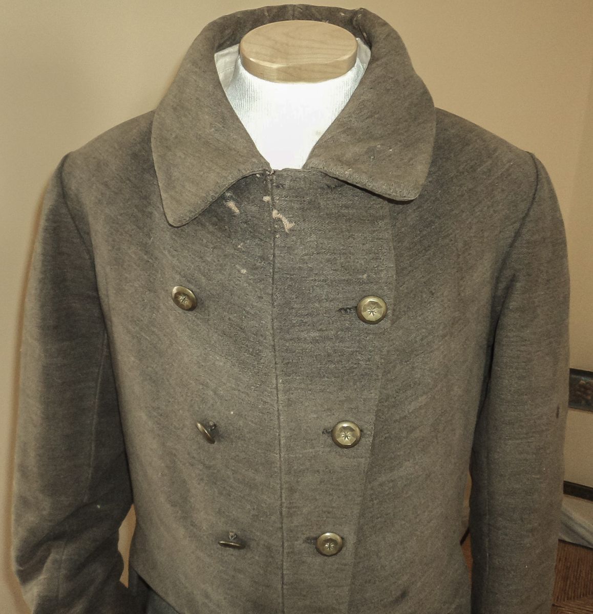 Note the course homespun material and plain brass buttons.