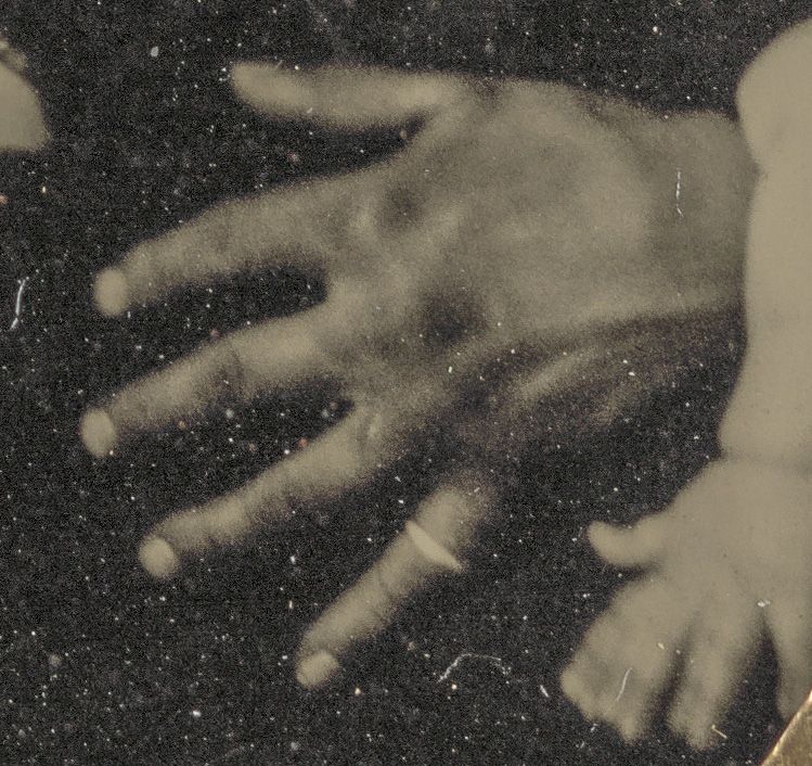 Close up of the soldiers hand with his wedding ring.