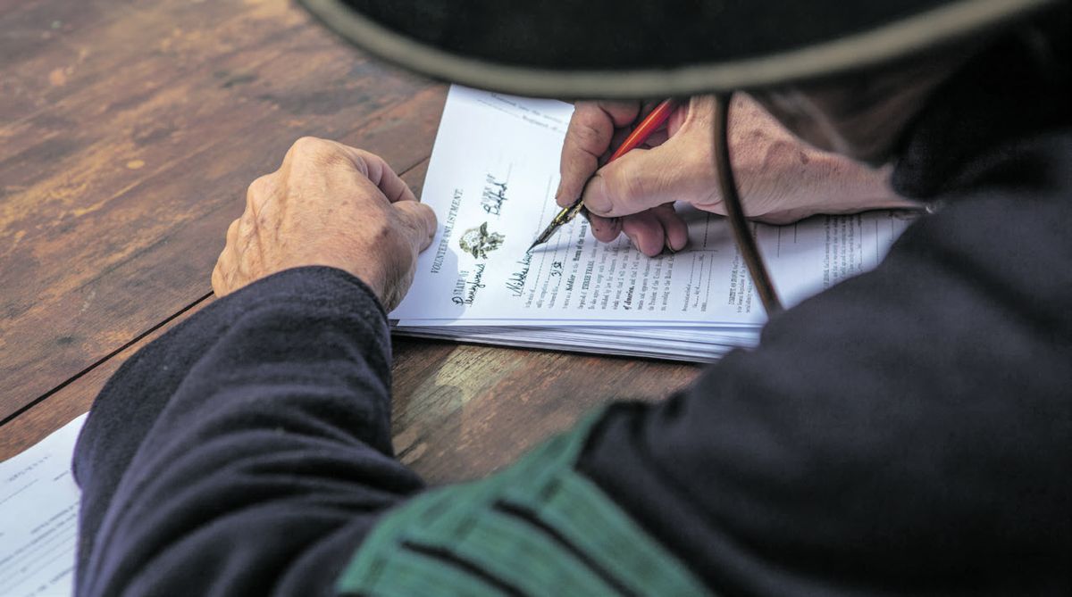 Marc Benedict, of Terre Hill, Penn., fills out an enlistment form.