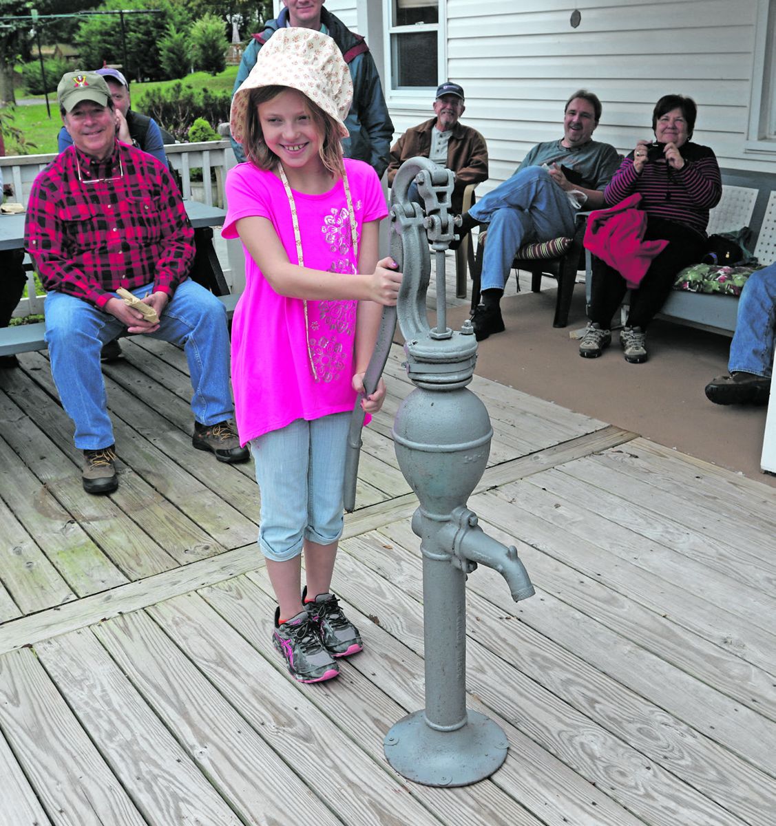 A young girl named Danielle from the Moravian Church in Graceham, Md., at a pump located where Belva Anne Elizabeth Coleman pumped water for Confederate cavalry members and their horses in front of her father’s store on July 5, 1863.