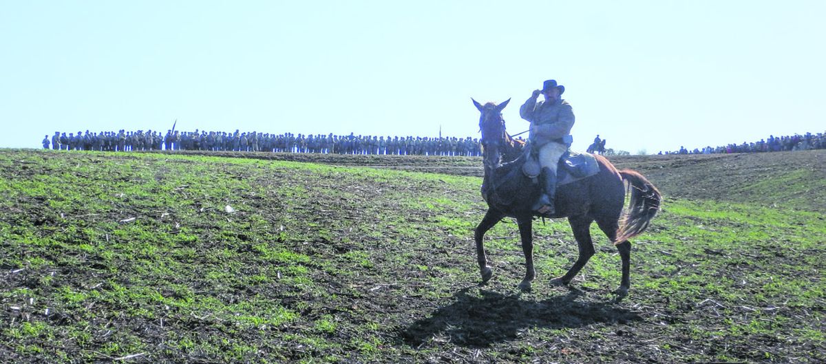 Mounted trooper in front of Confederate line ready to advance.