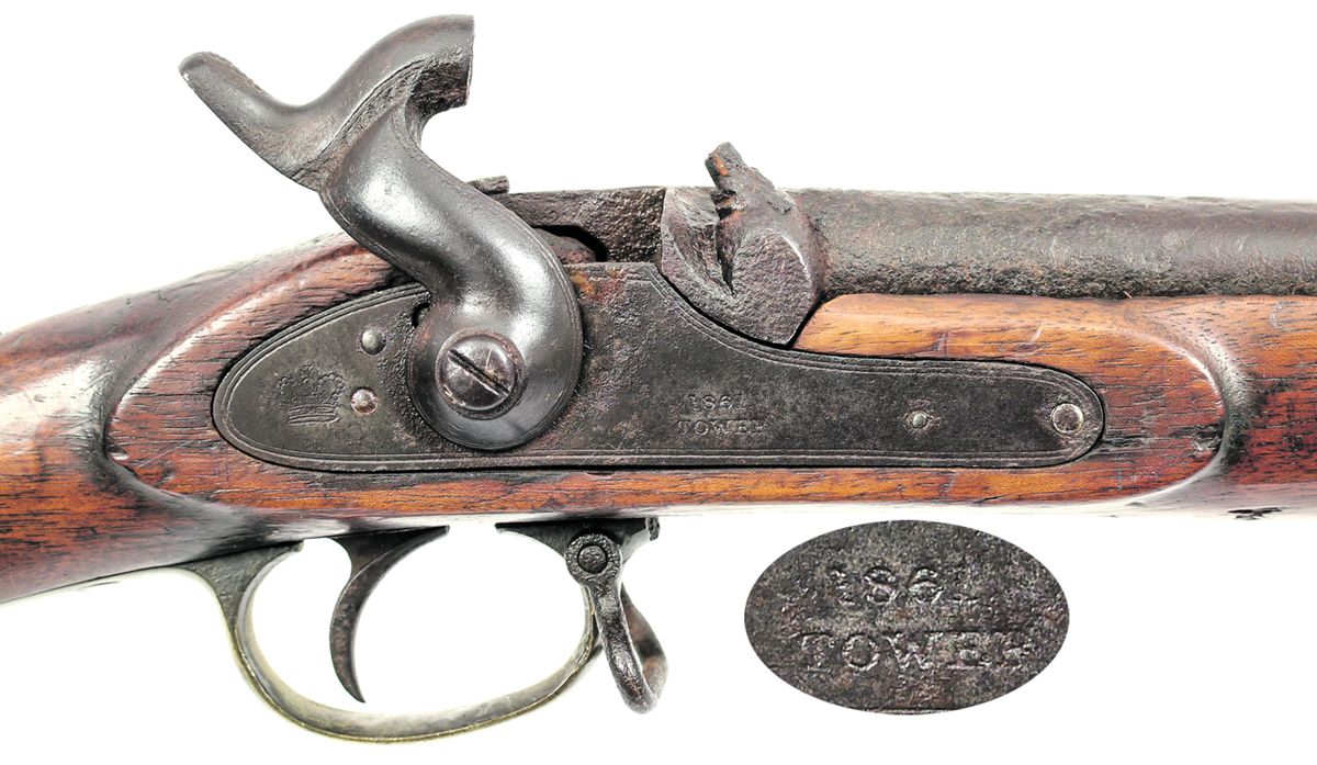 Close up of the lock area of the well-used Bar on Band rifle #3513, which is dated “1861” over the word “Tower.”