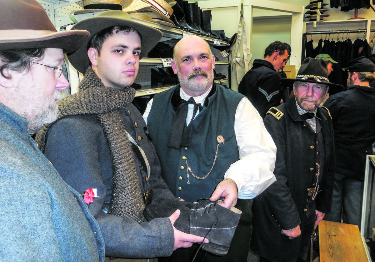 Mike at the Regimental Quartermaster, attempting to convince two confederates soldiers, that the shoes are not free.