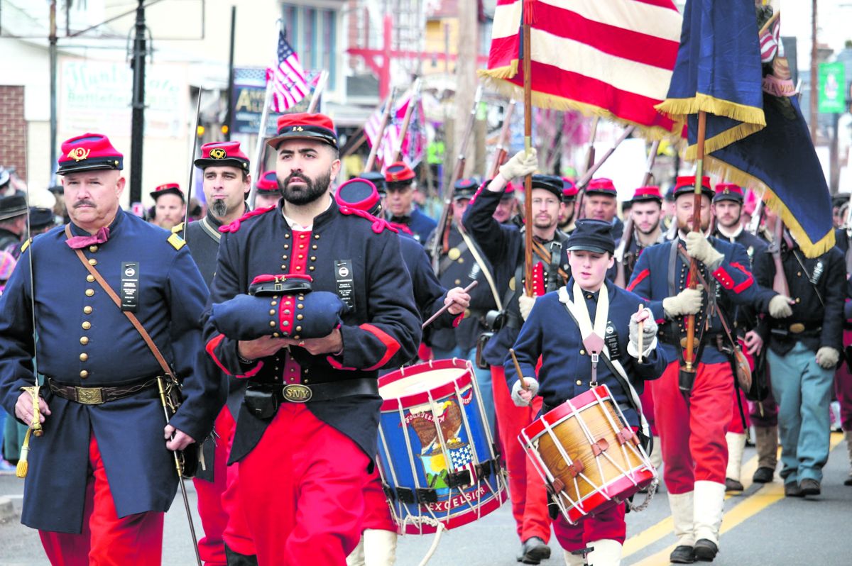 Members of the 14th Brooklyn carry the uniform of Frank J. Santella in Remembrance Day parade.