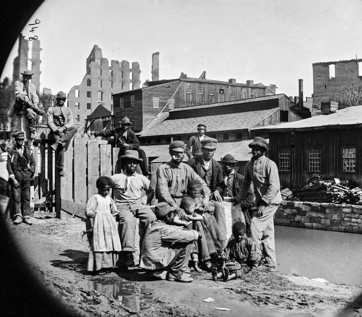 Freed slaves smile for the camera amidst the ruins of Richmond in 1865. (Library of Congress)