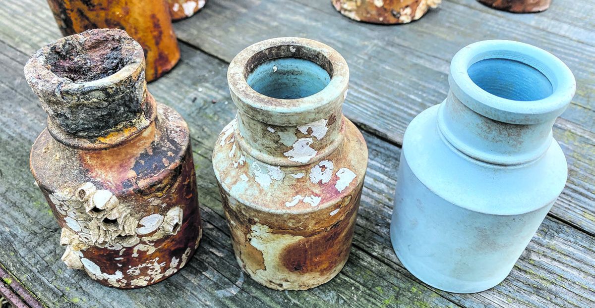 Small ink bottles showing them while being cleaned of concretions. (Bill Bleyer)