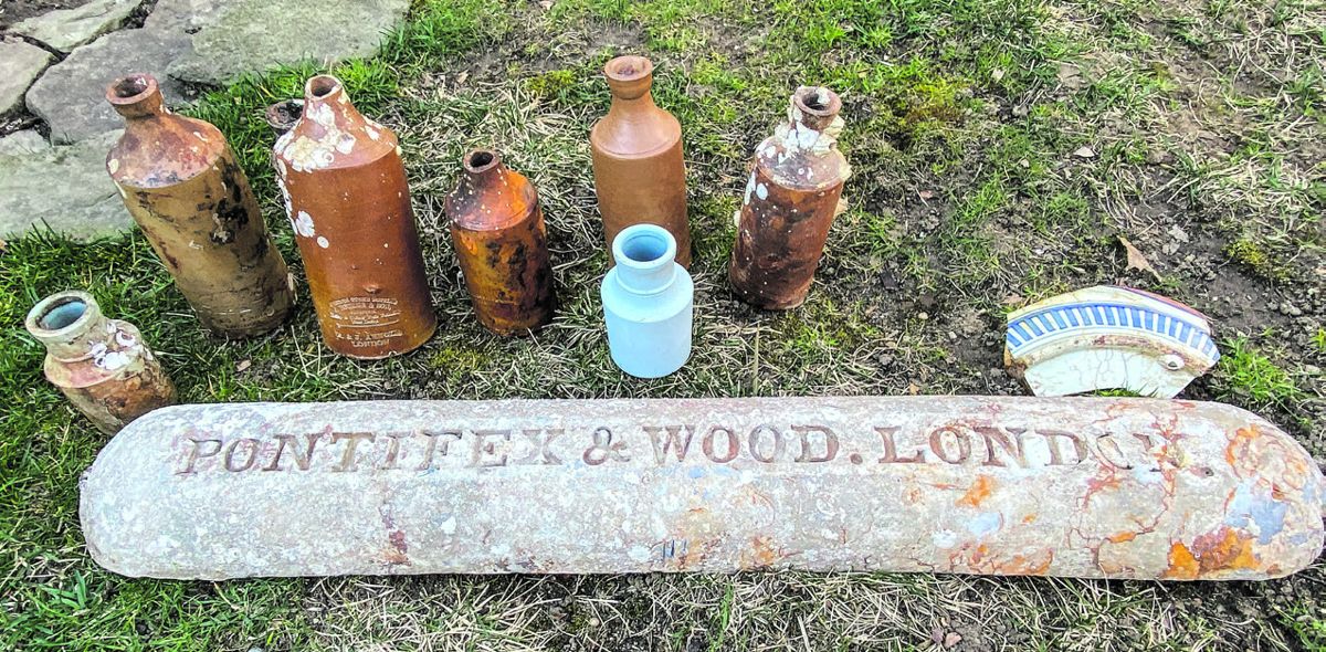 Ink bottles and a lead ingot recovered from the wreck. (Bill