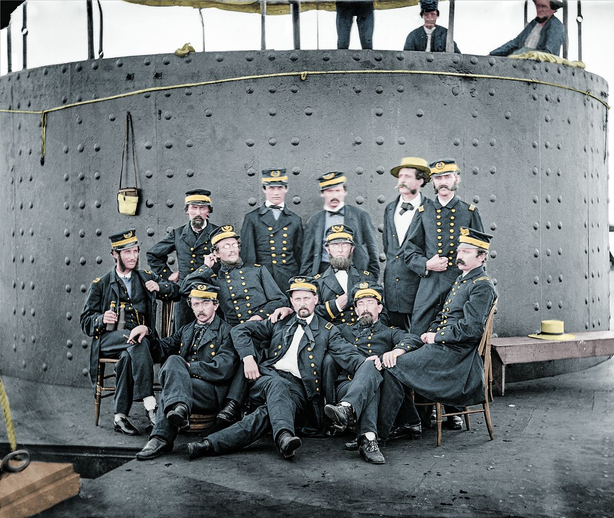 Officers of the USS Monitor grouped by the turret, Keeler seated second row, second from left, James River, Va., Colorization © 2020 civilwarincolor.com, courtesy civilwarincolor.com/cwn. (Library of Congress)