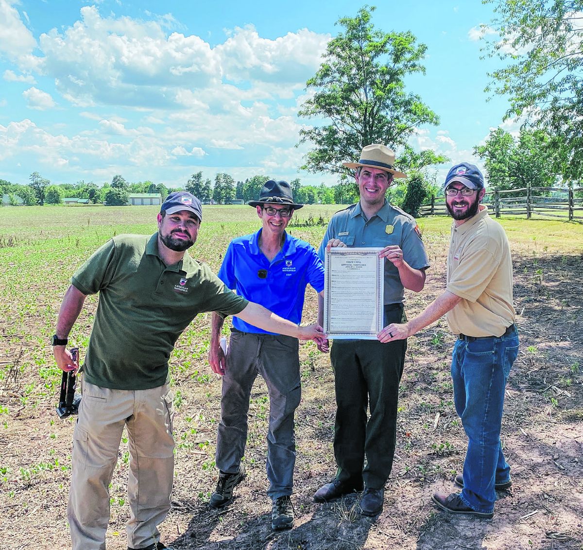 Trust Education Department members Kris White, Garry Adelman and Dan Davis present Gettysburg National Military Park Chief of Interpretation Chris Gwinn with the ceremonial deed for 35 acres at Barlow’s Knoll. American Battlefield Trust.