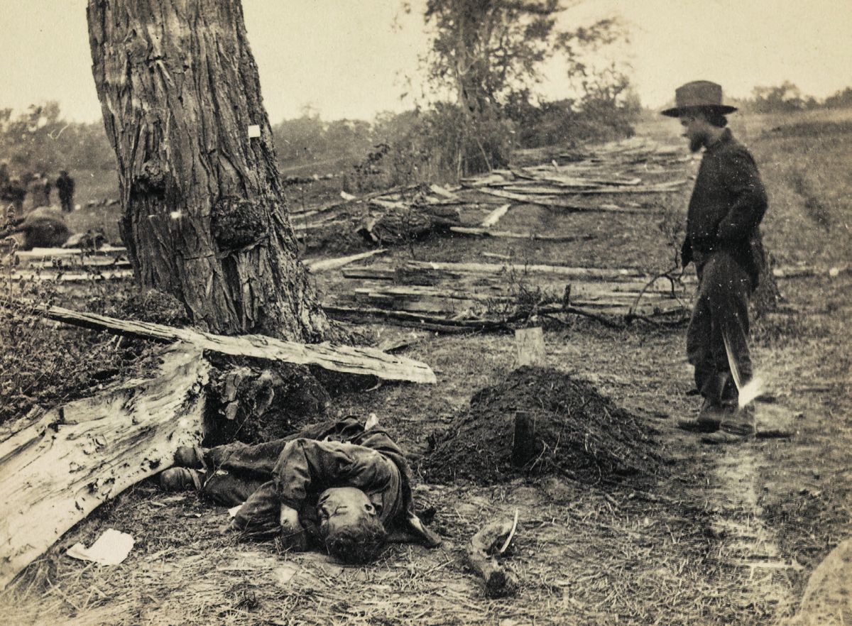 Near the West Woods, unburied Confederate lying beside the battlefield grave of Lt. John A. Clark of the 7th Michigan Infantry, both KIA on America’s bloodiest day. Photograph taken by Alexander Gardner on Sept. 19. Information on the photo taken from William A. Frassanito’s Antietam: A Photographic Legacy of America’s Bloodiest. Library of Congress.