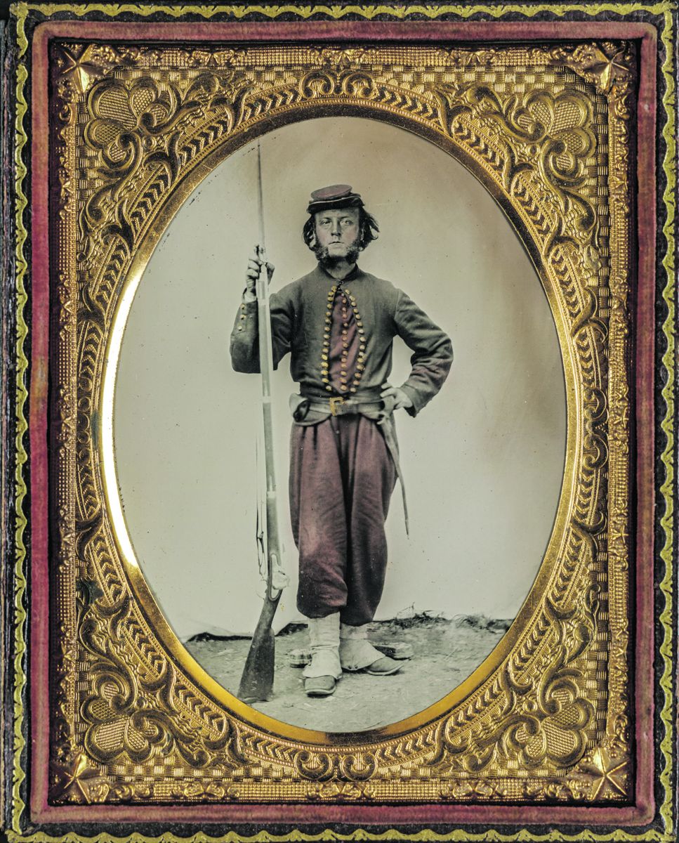 Unidentified soldier in Union zouave uniform with bayoneted musket with initials A.T. on stock. The hand tinting has faded over time. Liljenquist Family Collection of Civil War Photographs, Library of Congress.