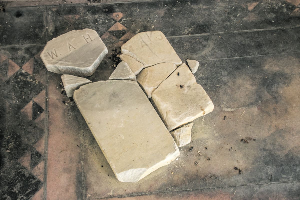 Broken foot stones inside the mausoleum.