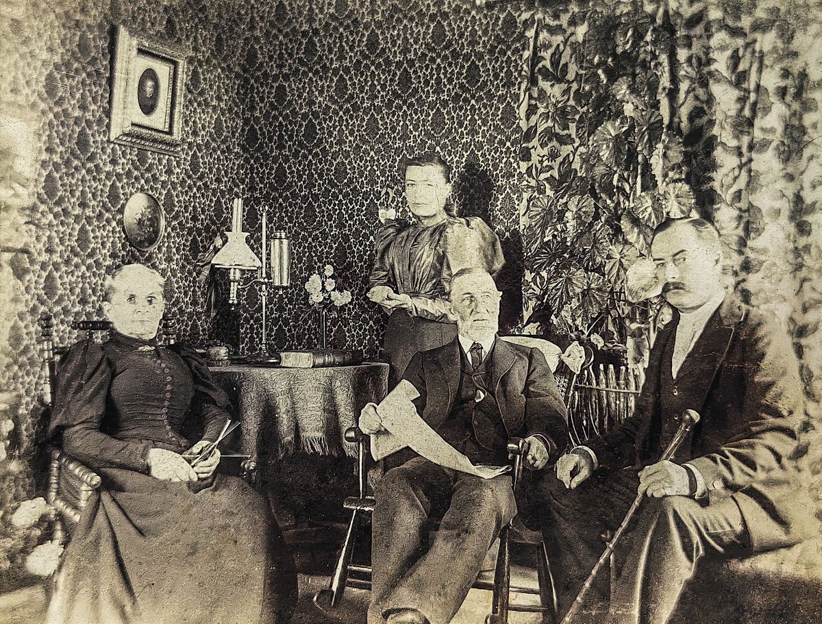 Postwar image of Josiah Baker (seated center), wife Alcinda (seated left), son George (seated right), and daughter Fannie (standing), in sitting room at Osburn. Courtesy, McCormick CWI.