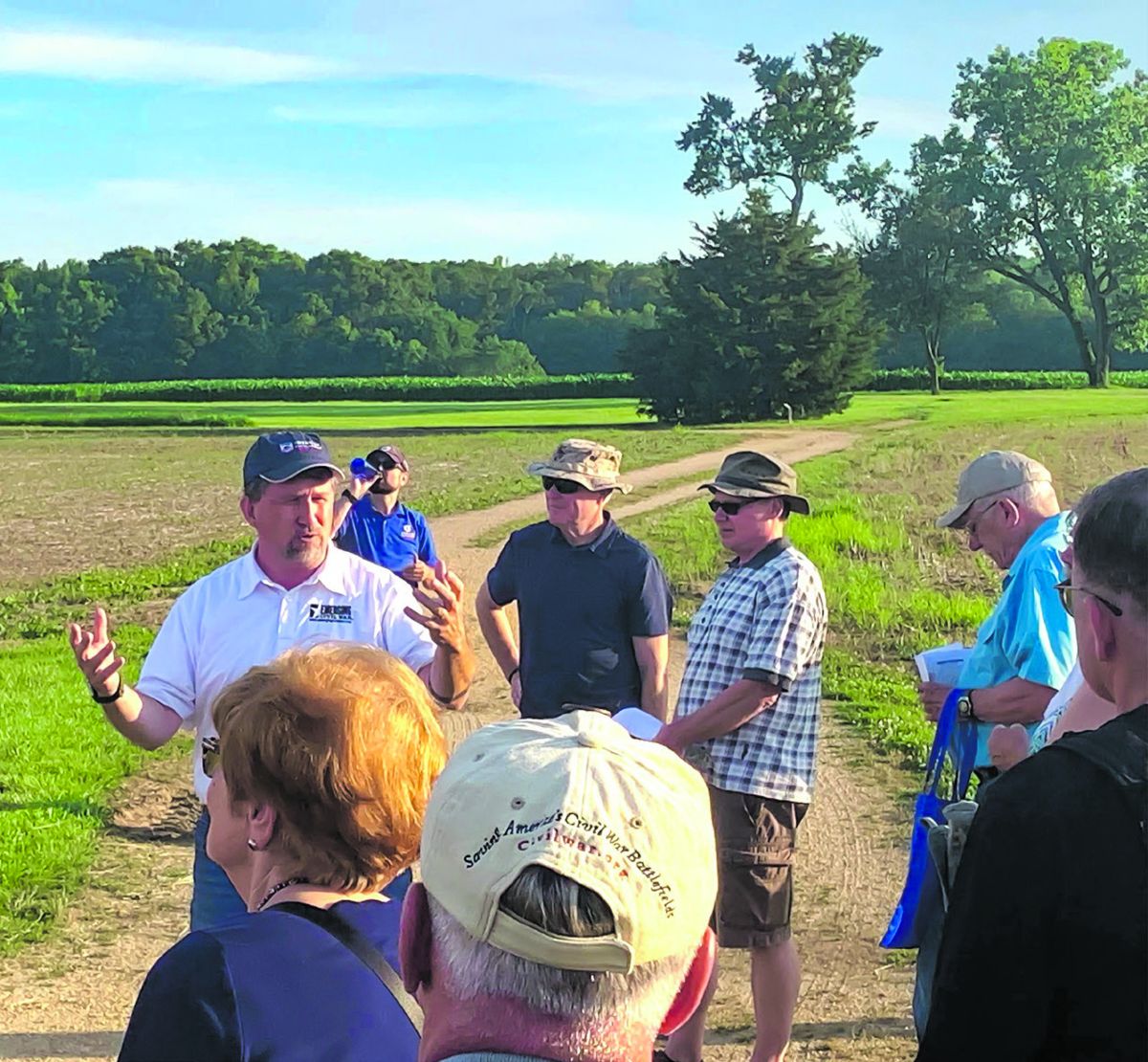 Chris Mackowski (white shirt, left) gesticulates wildly; behind him, Kris White takes a swig of water while on tour in Fredericksburg.