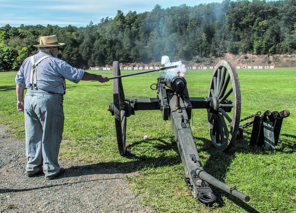 Fred Bane of the First Virginia Volunteer Infantry uses a linstock with slow match to light the quill and fire a James Type III cannon. When a cannon first ignites, flame shoots up from the vent a fraction of a second before the projectile launches from the muzzle. Ericka Hoffmann Curley.