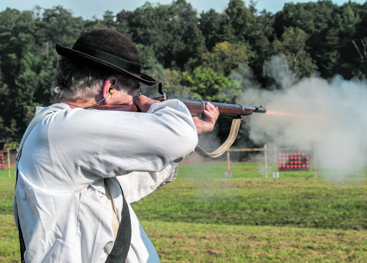Jack Boyenton of the 1st Virginia Volunteer Infantry fires his Enfield during the first event of the musket match; 32 clay pigeons on a cardboard backer. The eight-person musket teams compete to break all of the clay pigeons in the least amount of time. Ericka Hoffmann