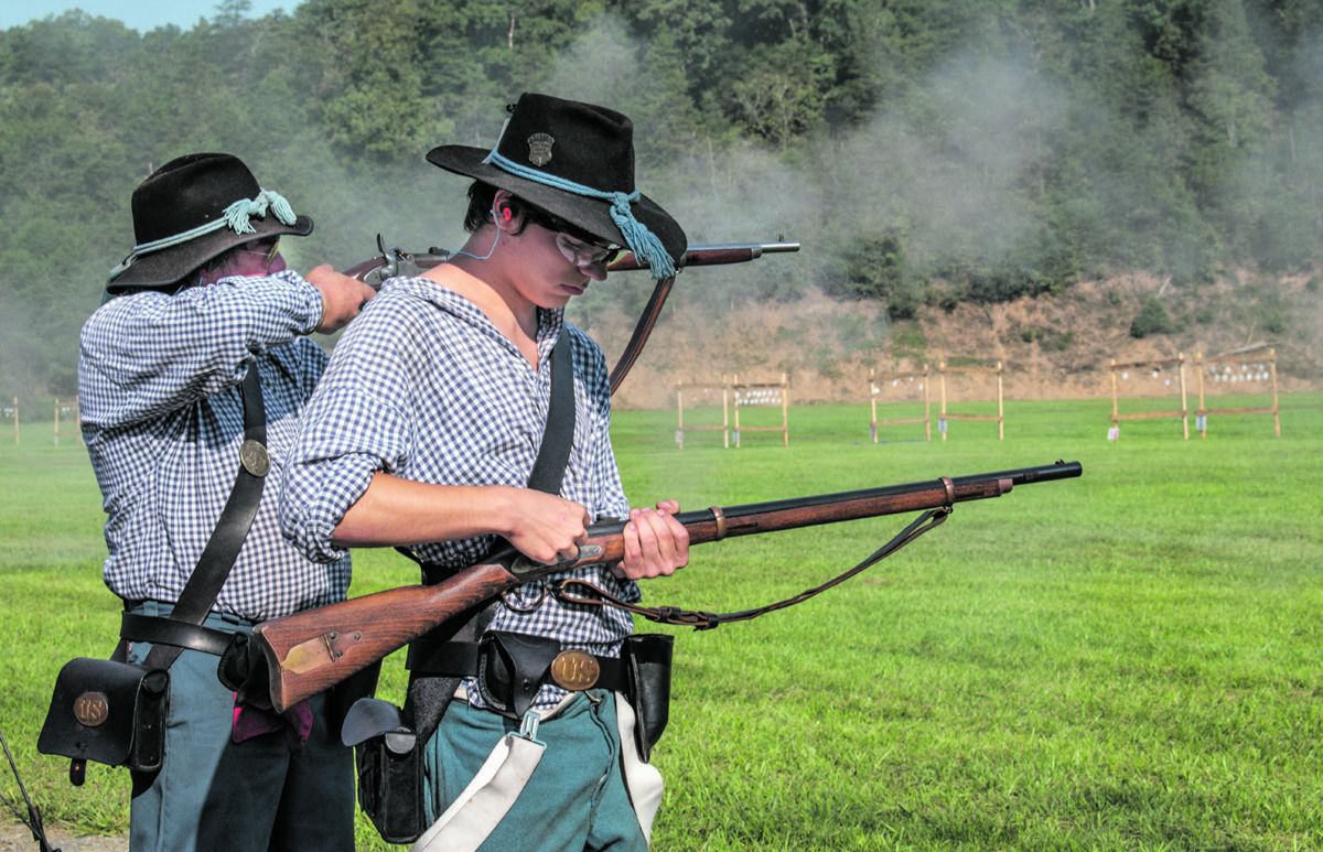Members of this Union team load and fire at four-inch hanging tiles during the musket match. At a National Skirmish, musket teams fill 65 line positions; the largest continuous firing line in the country. Ericka Hoffmann Curley.