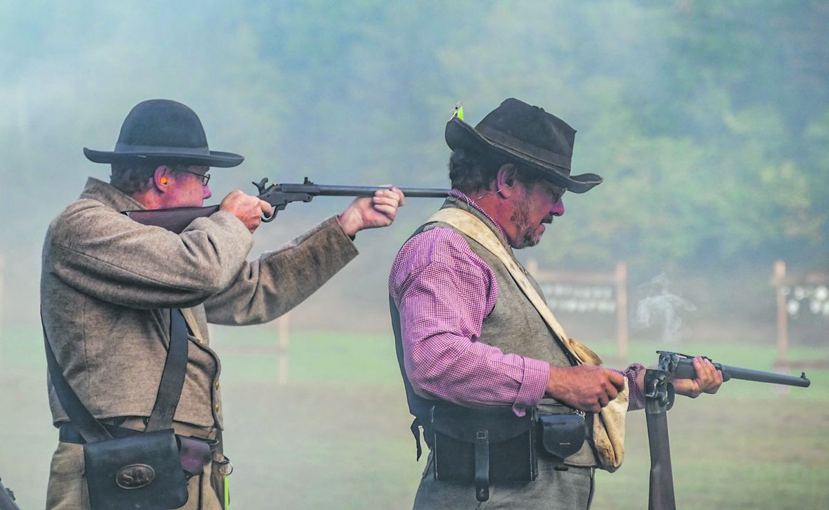 One member of this carbine team aims his Maynard carbine carefully through the black powder haze while his teammate reloads his Smith Members of the 1st Pennsylvania Rifles “Bucktails” and a member of Confederate team Hazlewood Volunteers work together to break pot carbine.