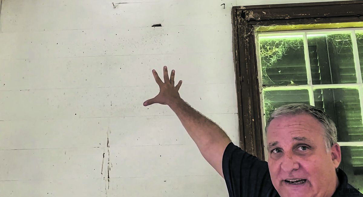 Historian Jim Woodrick points out battle damage in a house on the Port Gibson battlefield.
