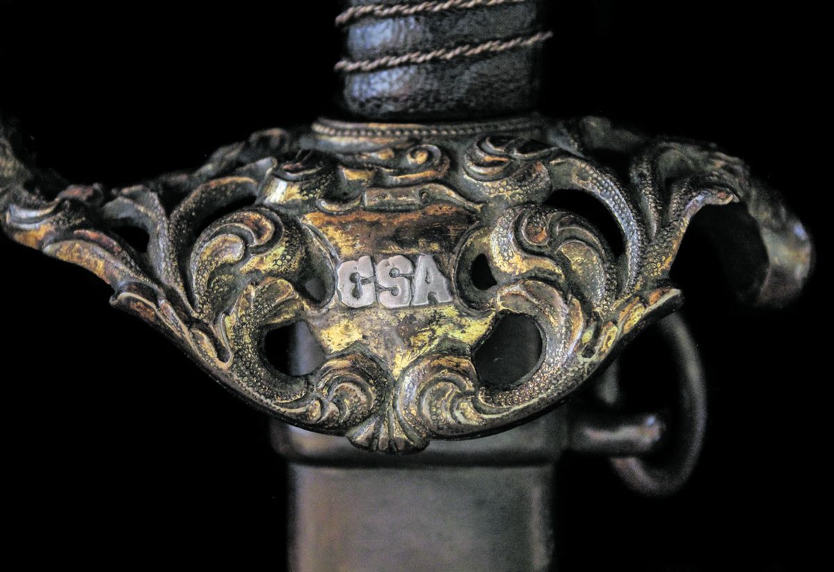 The down-turned guard is inlaid with a coin silver CSA.