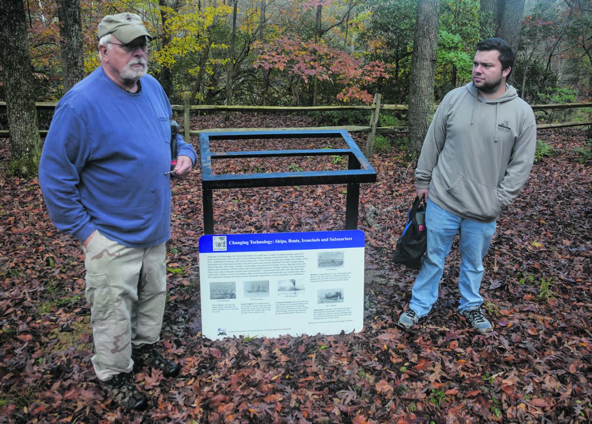 Bryan Grimes Camp SCV members Dan Mastin and Holden Spain preparing to mount sign