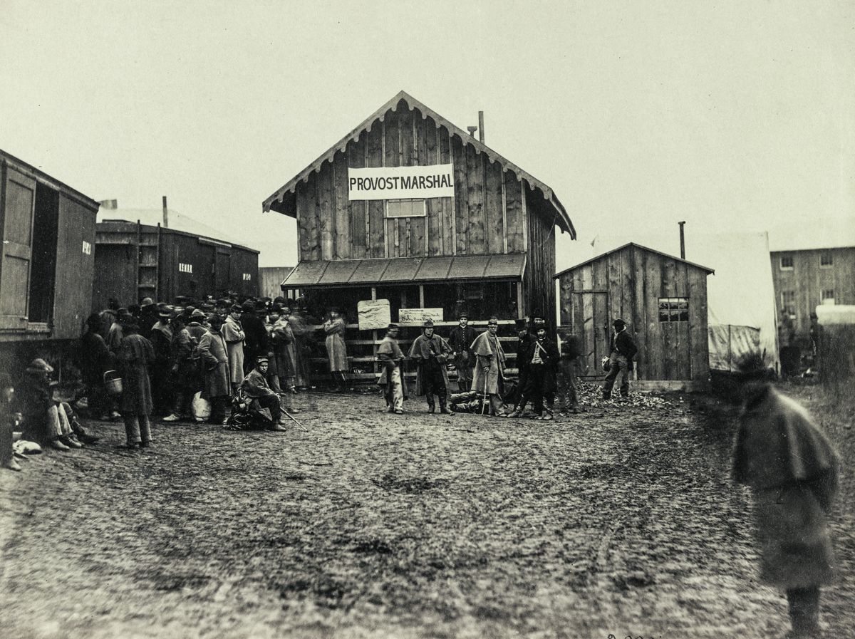Provost Marshal’s office draws a crowd near the train cars, Aquia Creek, Va., February 1863. Alexander Gardner. Library of Congress.