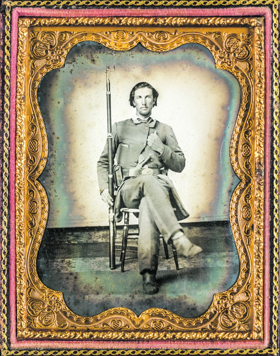 Confederate soldier in uniform holding a U.S. model rifle musket with bayonet. He has a cartridge box and knife on his accoutrement belt. Liljenquist Family Collection of Civil War Photographs (Library of Congress).