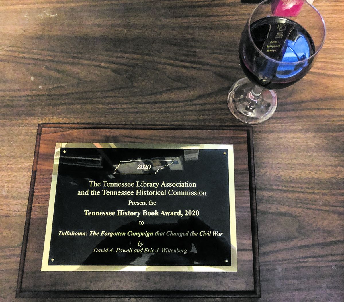 Dave Powell’s award plaque and a celebratory glass of shiraz.